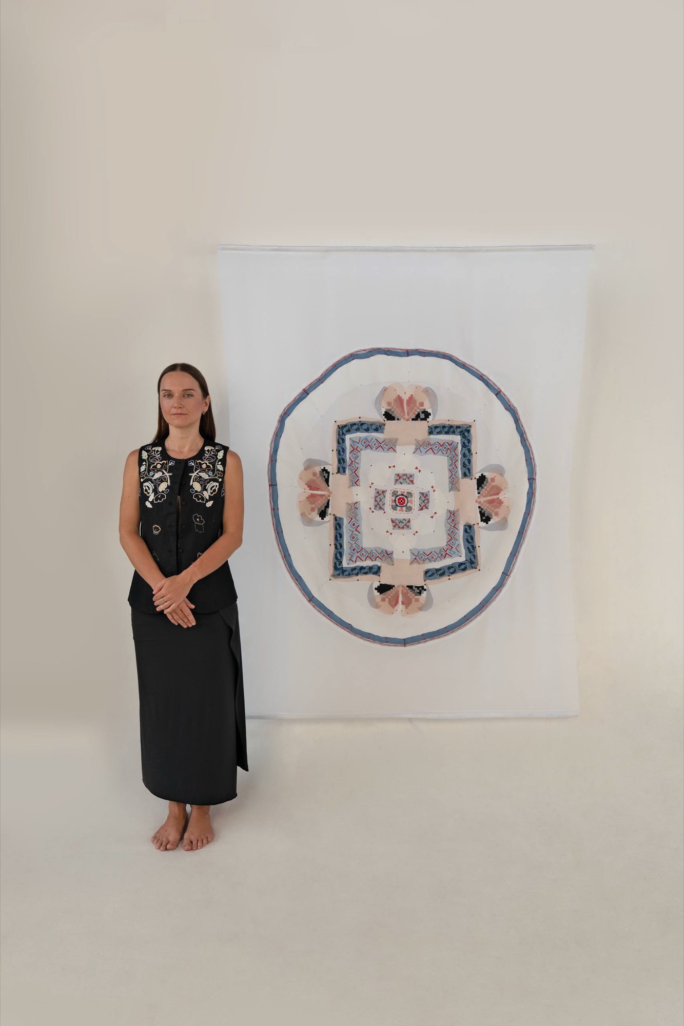 Kate Kulish standing beside The Tibetan Mandala in Ukrainian Thread