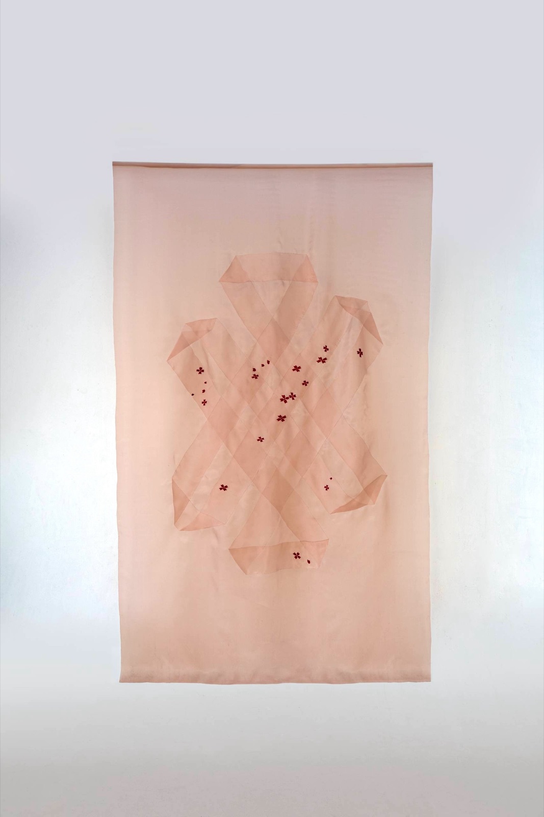 The Tibetan Knot in Ukrainian Thread — pale pink organza hanging with embroidered flowers
