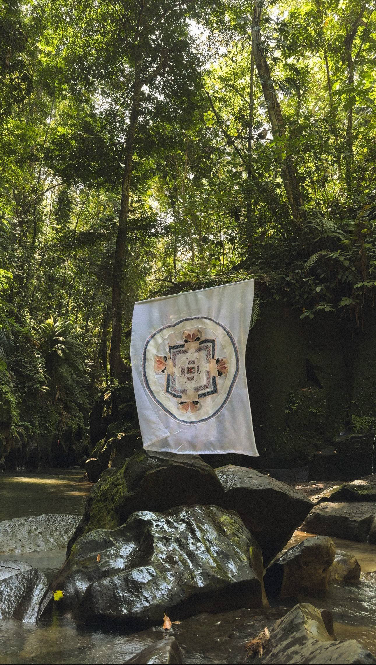 The Tibetan Mandala in Ukrainian Thread hanging in the jungle above a river
